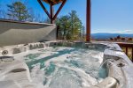 Covered Deck off Basement Features Large 7 Person Hot Tub, Rocking Chairs, Hammock, and Breathtaking Mountain Views